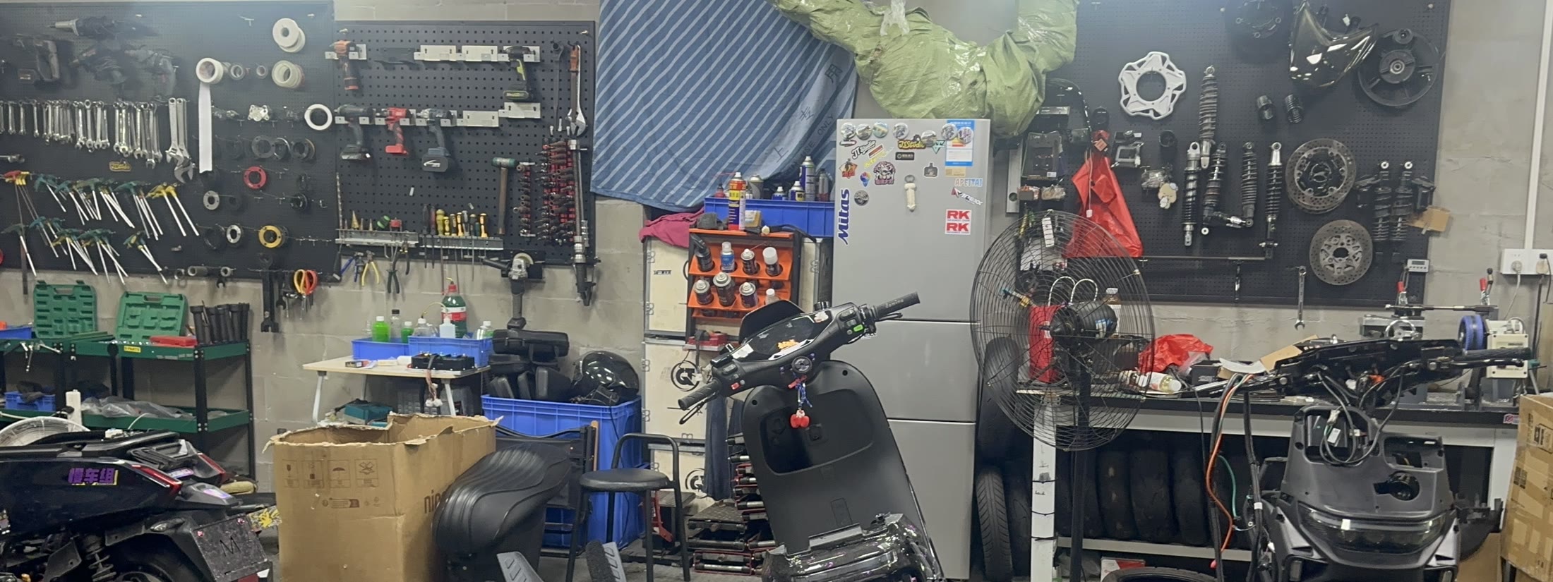 Ghostfire Archive workshop with electric motorcycles and parts prepared for custom builds