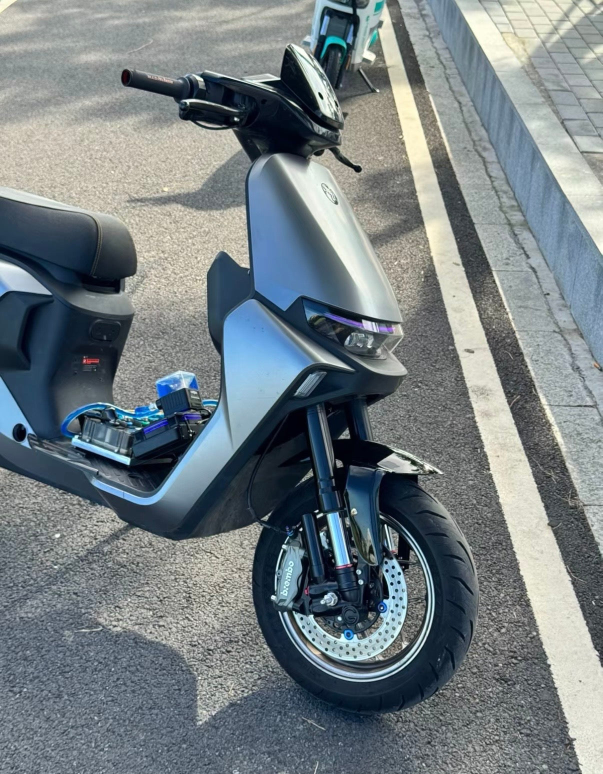Close-up of the front fork and braking system on a customized Ninebot electric motorcycle