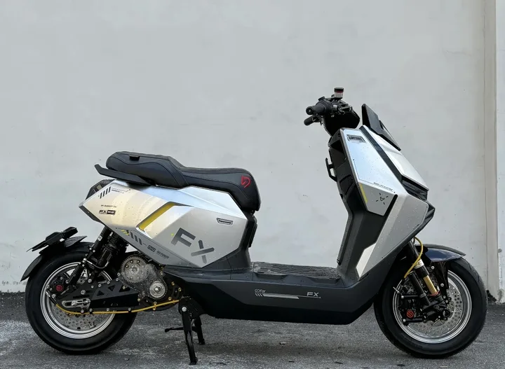 Side view of the silver NIU FX reference vehicle with secondary drive